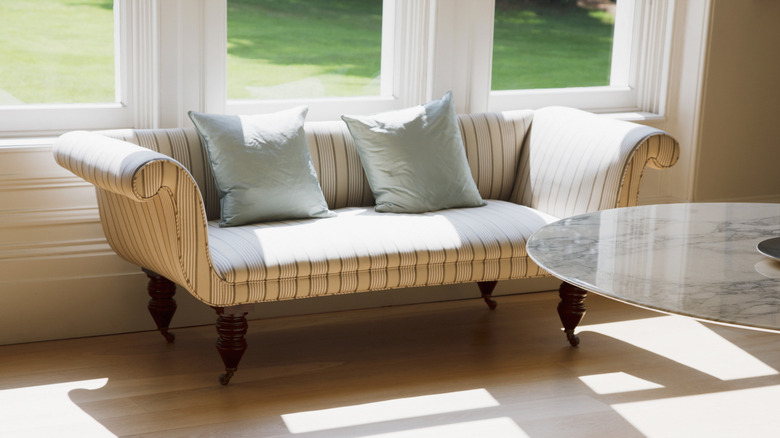 A French settee against a window in a modern interior