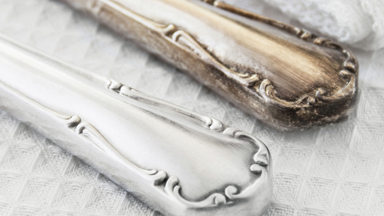 One tarnished piece of silver compared to a polished piece of silverware