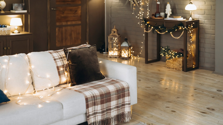 Plaid blanket on a couch in a living room decorated for the festive season