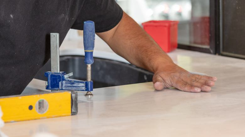 Person installing a Super White Quartz countertop