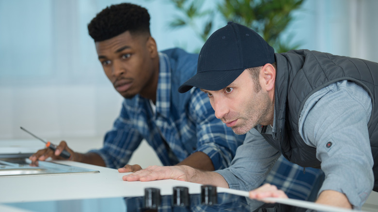 Two men studying a countertop