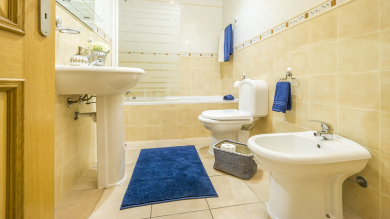 Small bathroom with beige tile floors and walls