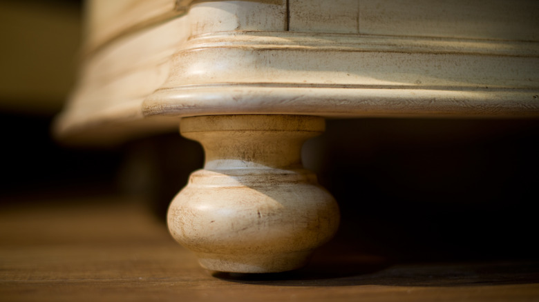 Closeup of wood feet at bottom of vanity
