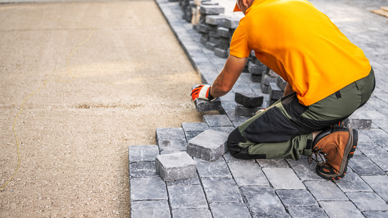 Professional installing concrete pavers