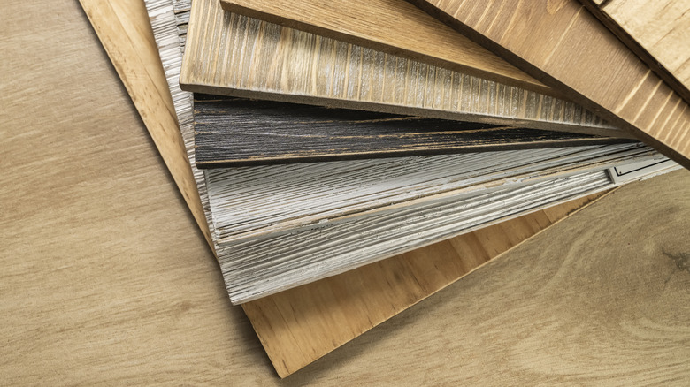 A stack of various construction sample wood boards.