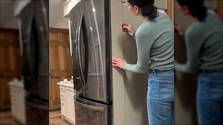 Person making a faux built-in refrigerator