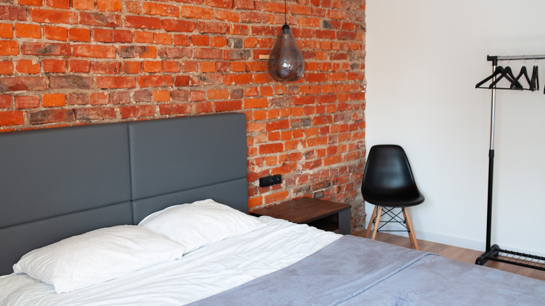 Bedroom with brick accent wall