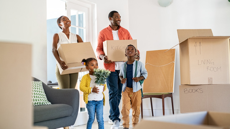 African American family moving in to a house