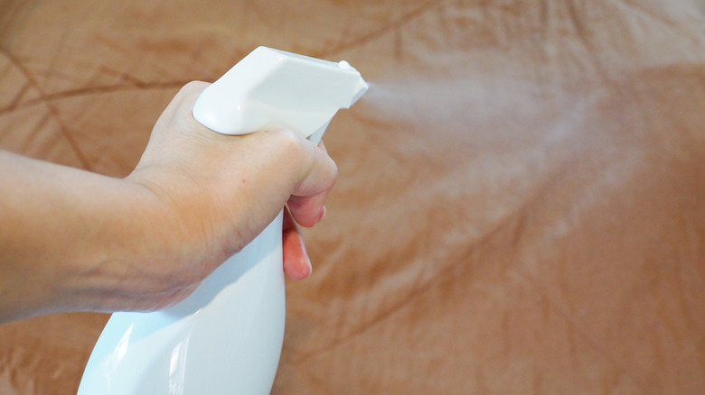 Spraying liquid onto bed sheets