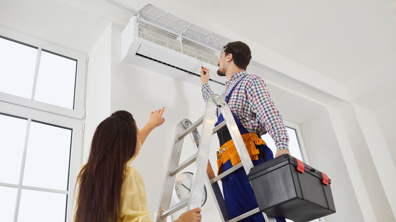 Person fixing air conditioner