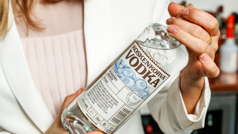 woman holding vodka bottle 