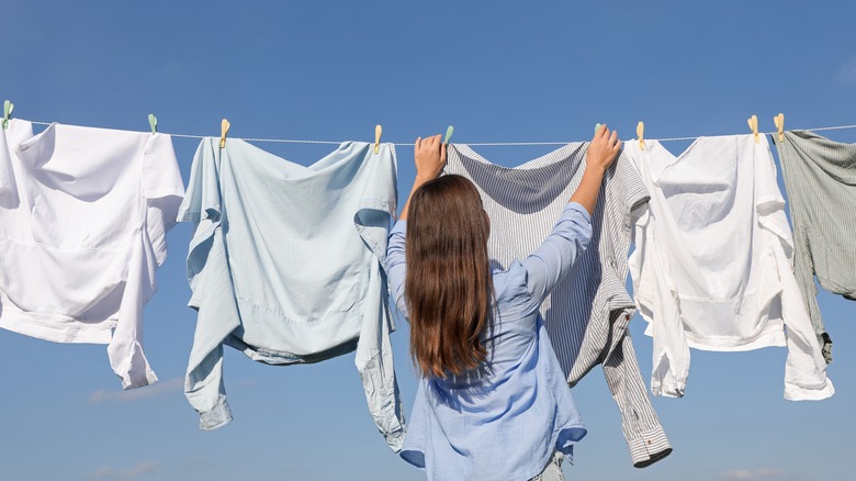 Woman hangs close on line outside