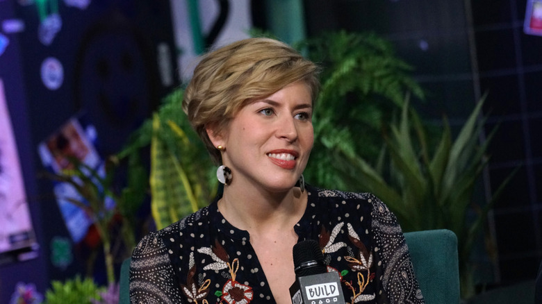Erin Napier sits during an interview holding a microphone