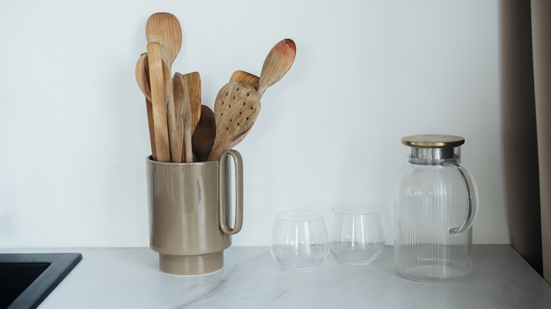 Cooking utensils sitting in a jar