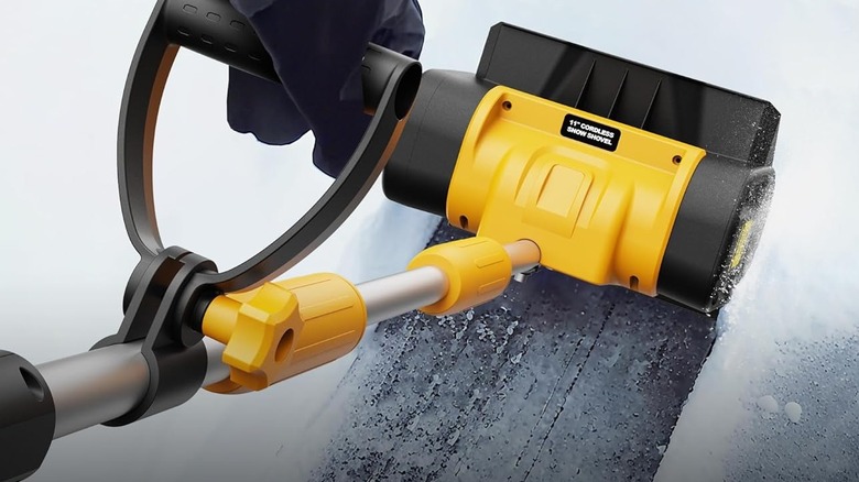 The yellow Houselife snow shovel available at Amazon being used to remove snow
