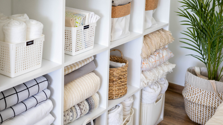 Neatly folded linens in a linen closet