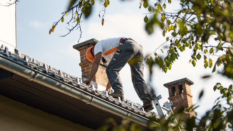 A man working on a roof on a clear day