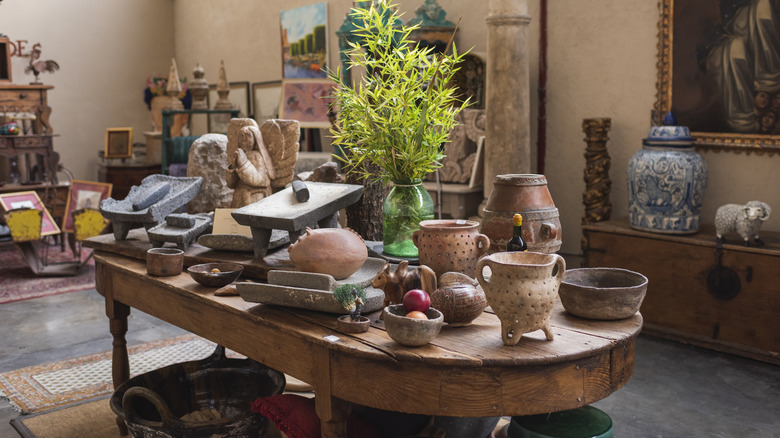 Antique handmade ceramics on display table in store