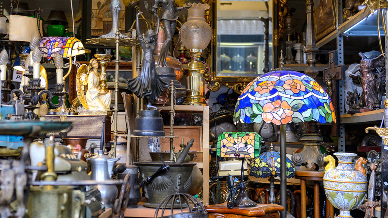 Interior of antique store selling colorful lamps, ceramics, and more