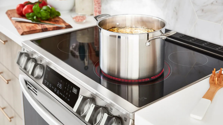 LG LSEL6335FE range in a kitchen with a pot with spaghetti on the front right element