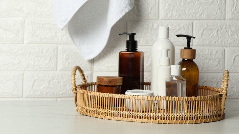 Bathroom items in decorative bottles on a tray