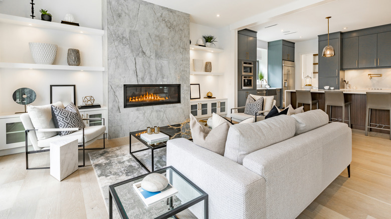 Contemporary-style living room with multiple side tables within reach of seating