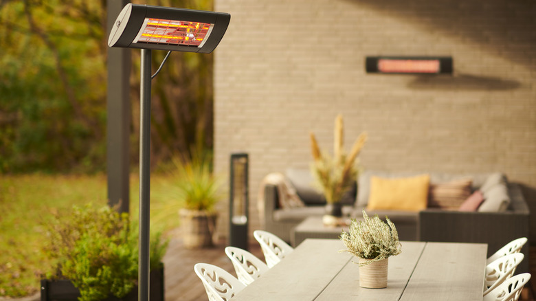 Electric heater on a patio near an outdoor dining set