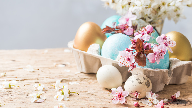Easter eggs flanked by spring flowers