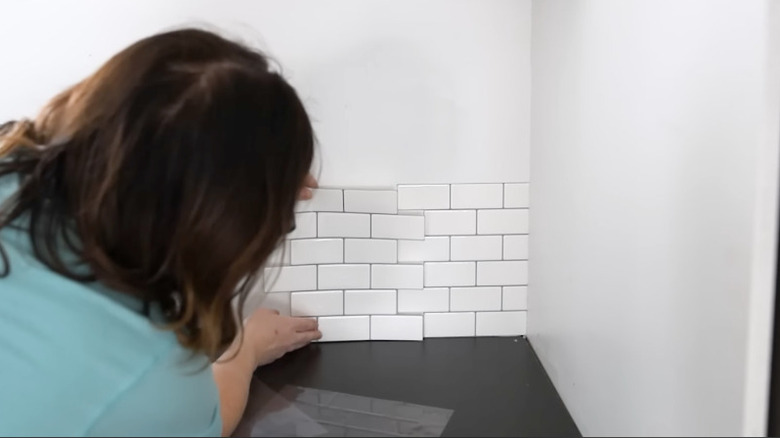 Installing white subway peel and stick tiles