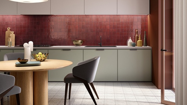 A modern kitchen with a red zellige backsplash
