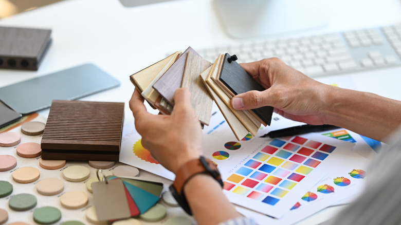 Person sorting through a collection of color samples
