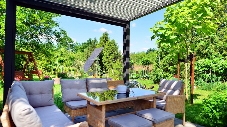 Pergola shade structure with contemporary seating and table.