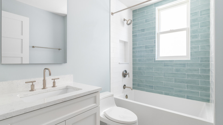 A white bathroom with icy blue tile