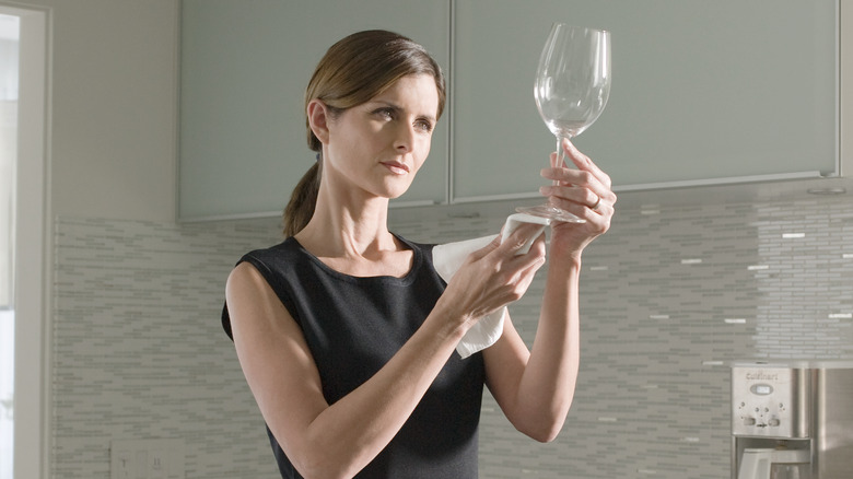 Woman cleaning a glass