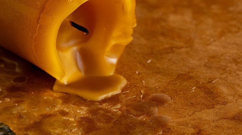 Tipped candle with wax on table