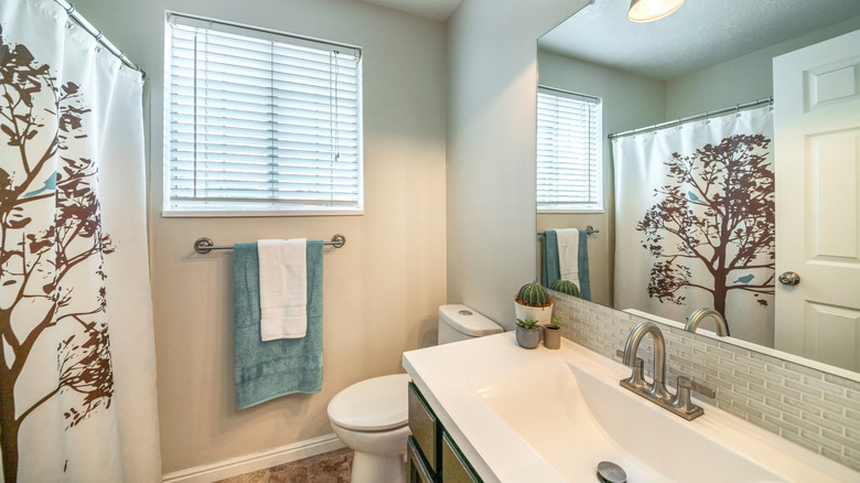 bathroom with towel bar near shower