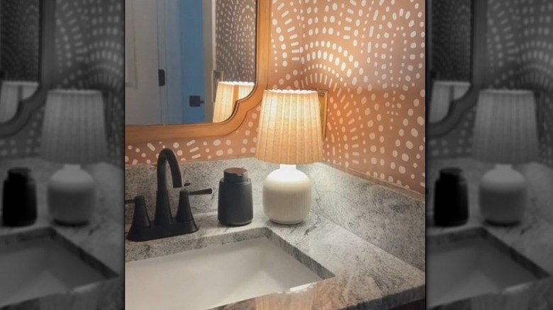 A table lamp placed on the bathroom vanity.