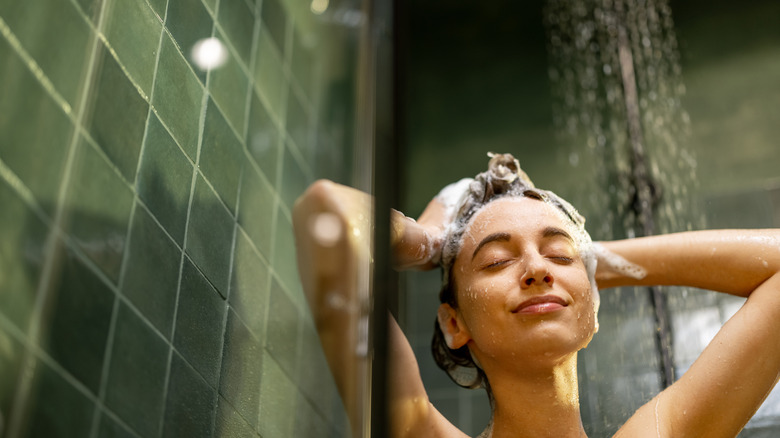 A happy woman enjoying her shower.