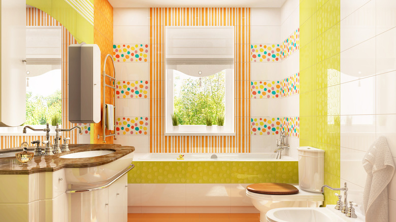 A modern bathroom with multiple patterns, colors, and textures.