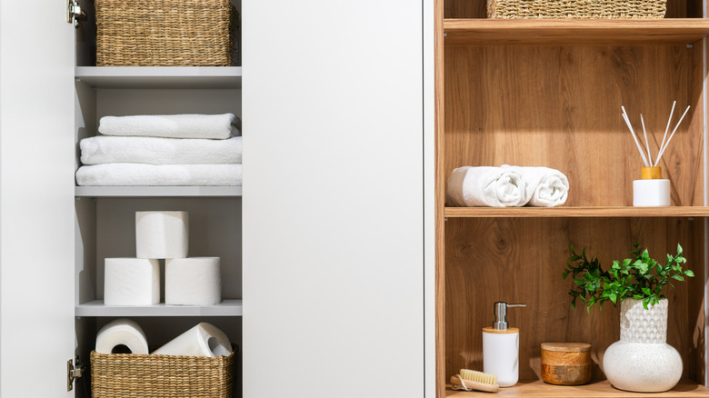 A shot showing two bathroom cabinets, one with doors, one without, both recessed into the wall