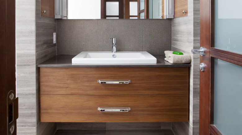 A floating vanity built to suit the specific space between two bathroom walls