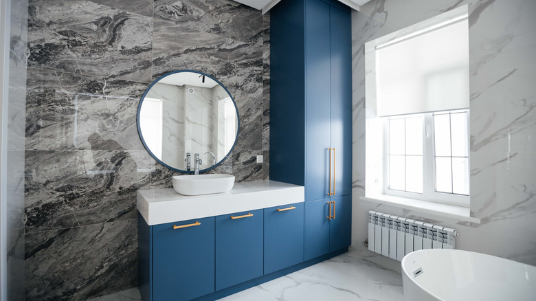 A modern bathroom with a floor-to-ceiling cabinet in the corner