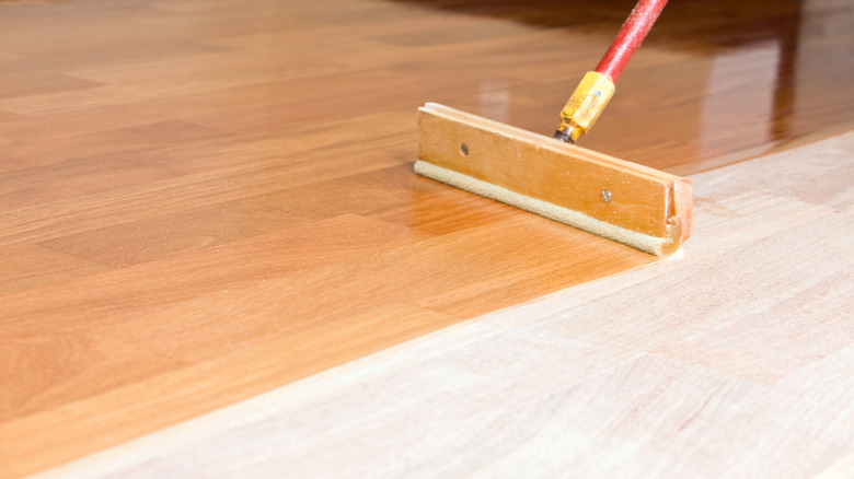 Person whitewashing floor