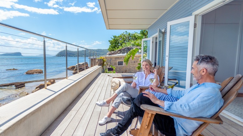 Couple sitting on waterfront porch