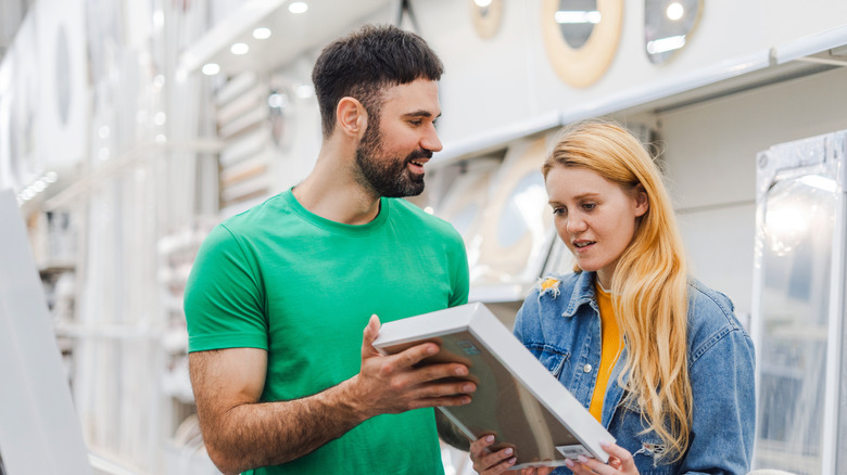 A couple at the store browsing wall decor