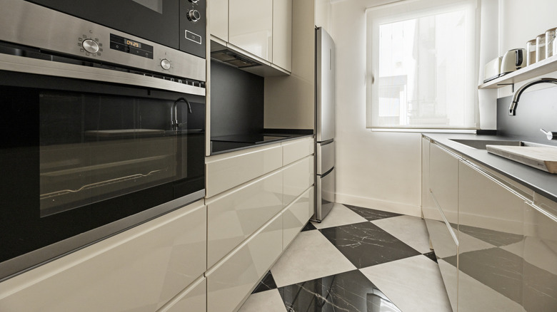 lacquered cabinet fronts become shiny reflective surfaces in a modern kitchen