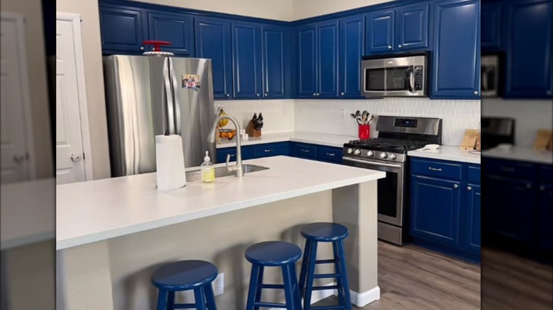 a kitchen with blue lacquered cabinets offers a pop of color and a friendly, playful vibe