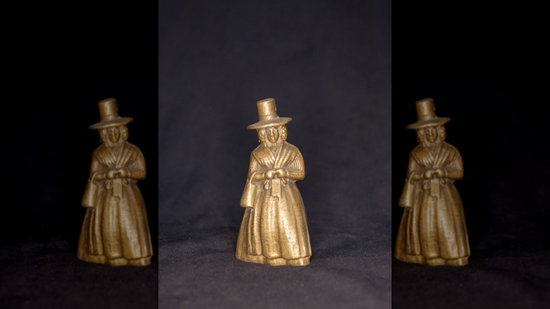 Brass lady bell on black background