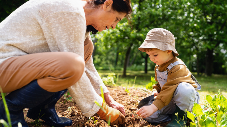 woman and child planting garden