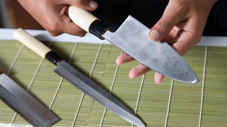 Hand holding kitchen knives